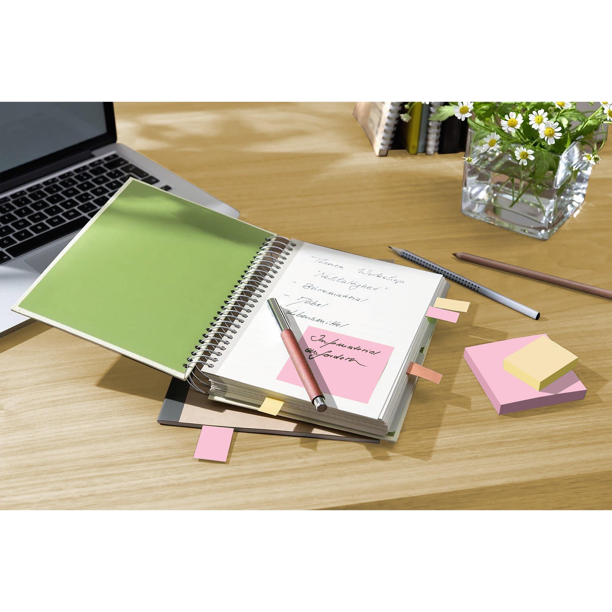 Ein Notizbuch mit handschriftlichen Notizen und 3M Post-it® Recycling Notes (38 mm x 51 mm, 100% PEFC) liegt aufgeschlagen auf einem Holztisch neben einem Laptop, Stiften und einer Vase mit weißen Gänseblümchen.