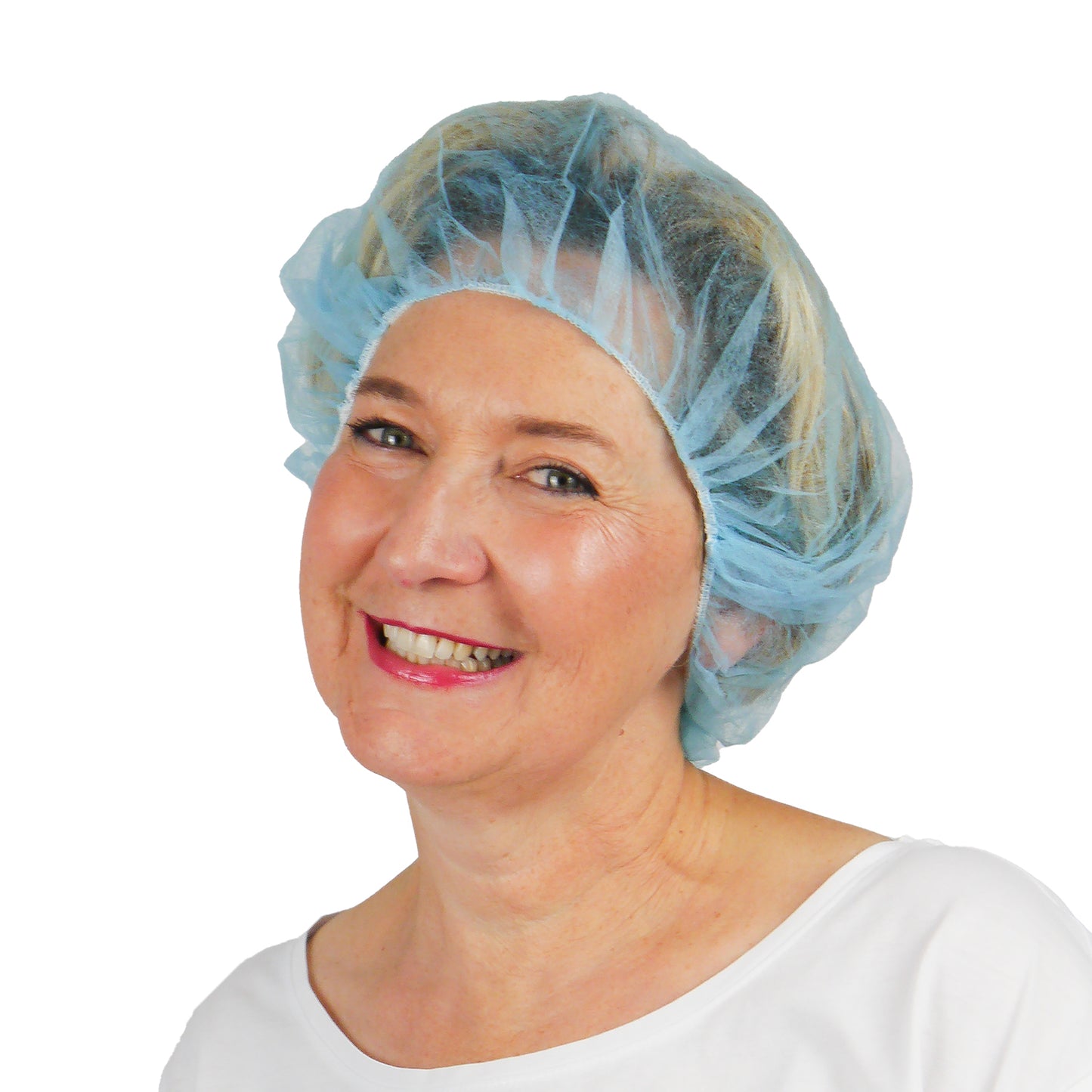 Een vrouw in een lichtblauwe ARNOMED COVER PP-BARETTHAUBE baretkap van PP-vlies van ARNOWA GmbH en een wit bovenstuk glimlacht voor een eenvoudige witte achtergrond en benadrukt dit hygiënische accessoire voor de hygiënezone.