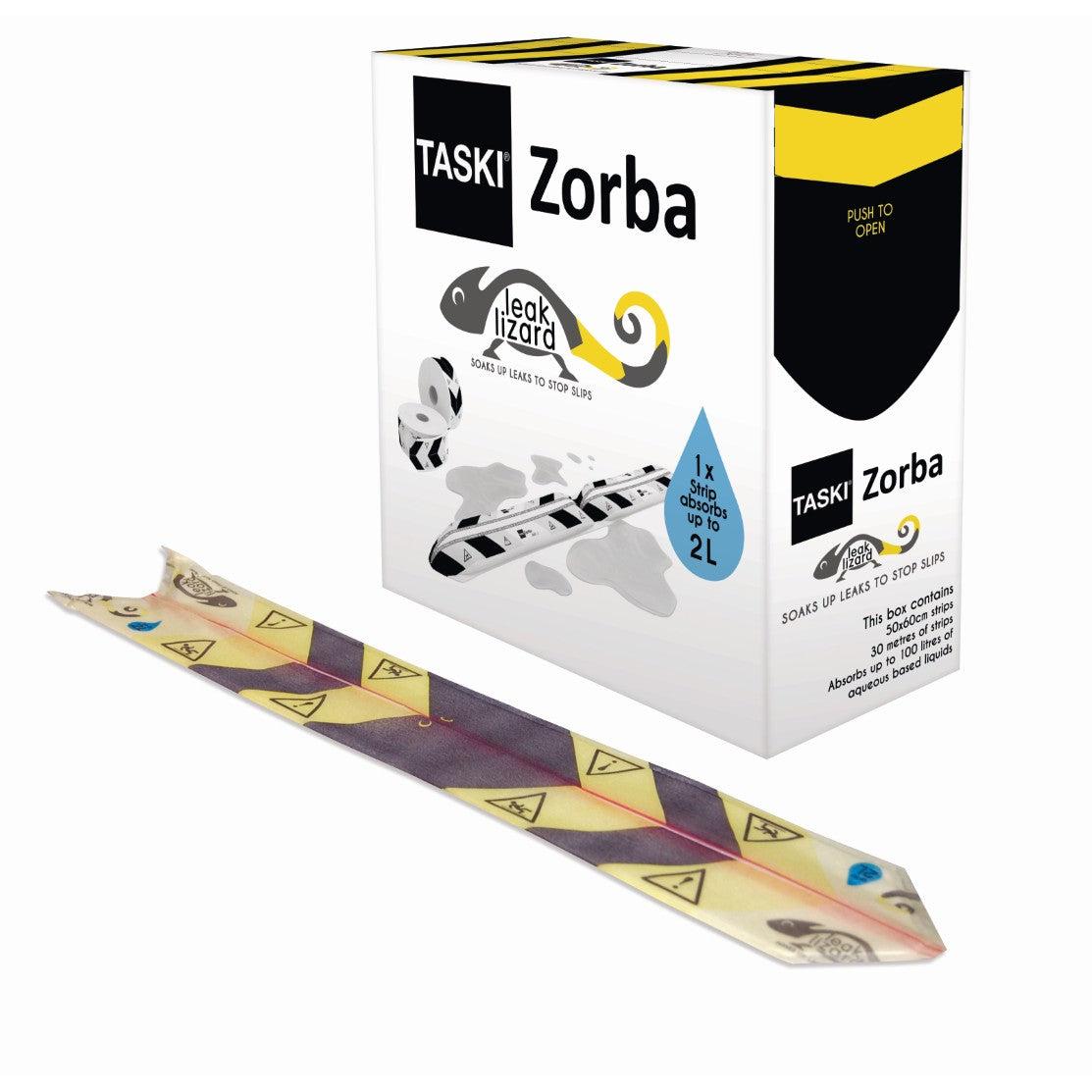 Achter een geel-witte, zeer effectieve absorptiestrook (1 doos = 50 x 60 cm) bevindt zich een doos TASKI Zorba Leak Lizard van Diversey Deutschland. De verpakking beweert dat het tot 2 liter absorbeert voor het snel opruimen van lekkages.