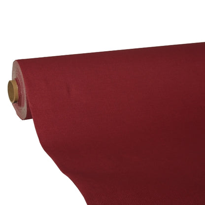 Un rouleau de nappe rouge foncé tissu « ROYAL Collection » de PAPSTAR GmbH est partiellement déroulé sur un rouleau en carton. La qualité de tissu haut de gamme assure une apparence lisse et opaque.