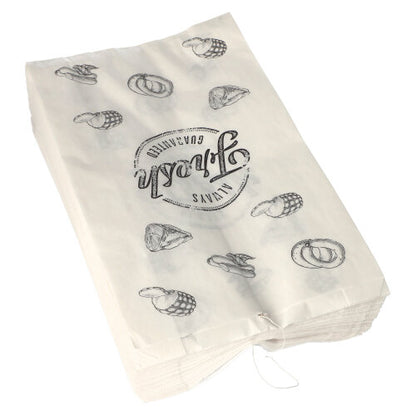 Een stapel PAPSTAR 1000 slagerszakken van kraftpapier, geregen, van PAPSTAR GmbH, met zwarte illustraties van pretzels, cupcakes en het cirkelvormige opschrift "Unna's Kwaliteit".