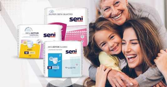 Eine glückliche ältere Dame, eine junge Frau und ein Kind lächeln und umarmen sich. Vor ihnen liegen Verpackungen von Seni-Inkontinenzprodukten, darunter Seni Active Normal, Seni Active Classic und Super Seni Quatro, beschriftet mit Produktinformationen.