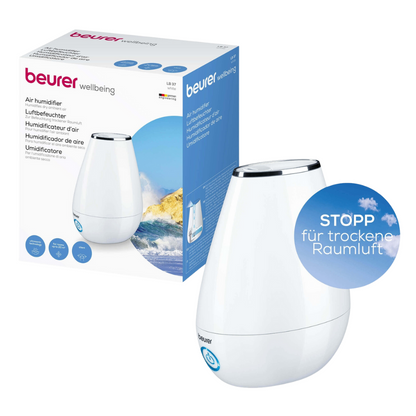 Image d'un produit humidificateur Beurer LB 37 avec emballage. L'humidificateur de Beurer GmbH présente un design élégant, blanc et en forme de goutte avec un bouton d'allumage bleu et une technologie d'humidification par ultrasons avancée. Sur l'emballage, on peut également voir l'image du produit et diverses descriptions en plusieurs langues.