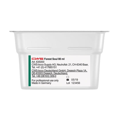 Un conteneur blanc rectangulaire avec l'inscription "CWS ParadiseLine Parfum pour salle de bain pour diffuseur de parfum Paradise Air Bar" de CWS affiche sur une étiquette blanche des informations sur le produit et l'entreprise, des coordonnées, la date de fabrication (05/19) et le numéro de lot (123456).