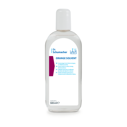 Une bouteille transparente de 500 ml de Dr. Schumacher GmbH ORANGE SOLVENT nettoyant pour instruments avec bouchon blanc et étiquette bleu-blanc, pour l'élimination de la colle et le nettoyage des instruments, présentée sur fond blanc.