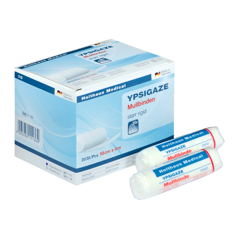 En plus de deux rouleaux individuels, une boîte avec un bandage en gaze Ypsigaze de Holthaus Medical GmbH & Co. KG est exposée. Le bandage rigide mesure 10 cm x 4 m et contient 20 pièces.