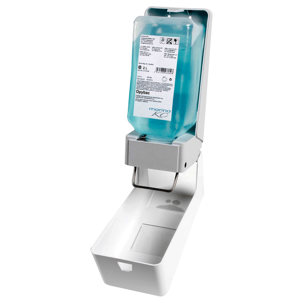 De Kiehl ManoDos-soft zeep- en crèmedispenser van Johannes Kiehl KG voor 1 L en 2 L zachte flessen heeft een metalen hendel, een blauwe sanitair fles, een open frontdeksel en een wit lekbakje aan de onderkant.