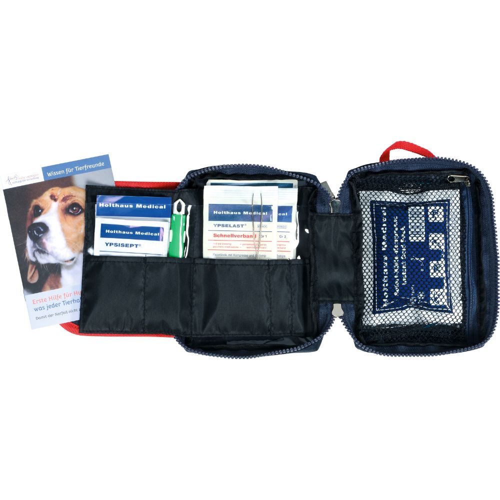 La trousse de premiers secours Holthaus Medical Pet Care de Holthaus Medical GmbH & Co. KG est un kit de premiers secours rouge avec des bandages, des lingettes antiseptiques et d'autres fournitures médicales dans des compartiments séparés. Sur le côté gauche, il y a un livret avec un visage de chien pour les soins d'urgence de votre animal.