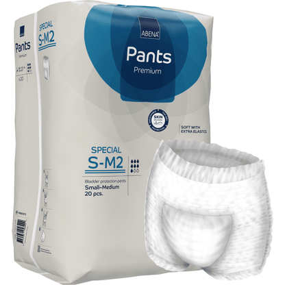 Un paquet d'ABENA Pants Special Premium de Abena Re-Seller GmbH, taille S-M2 (20 pièces), représenté à côté d'un pantalon blanc pour adulte déplié. L'emballage met en avant la protection de la peau et les élastiques supplémentaires.