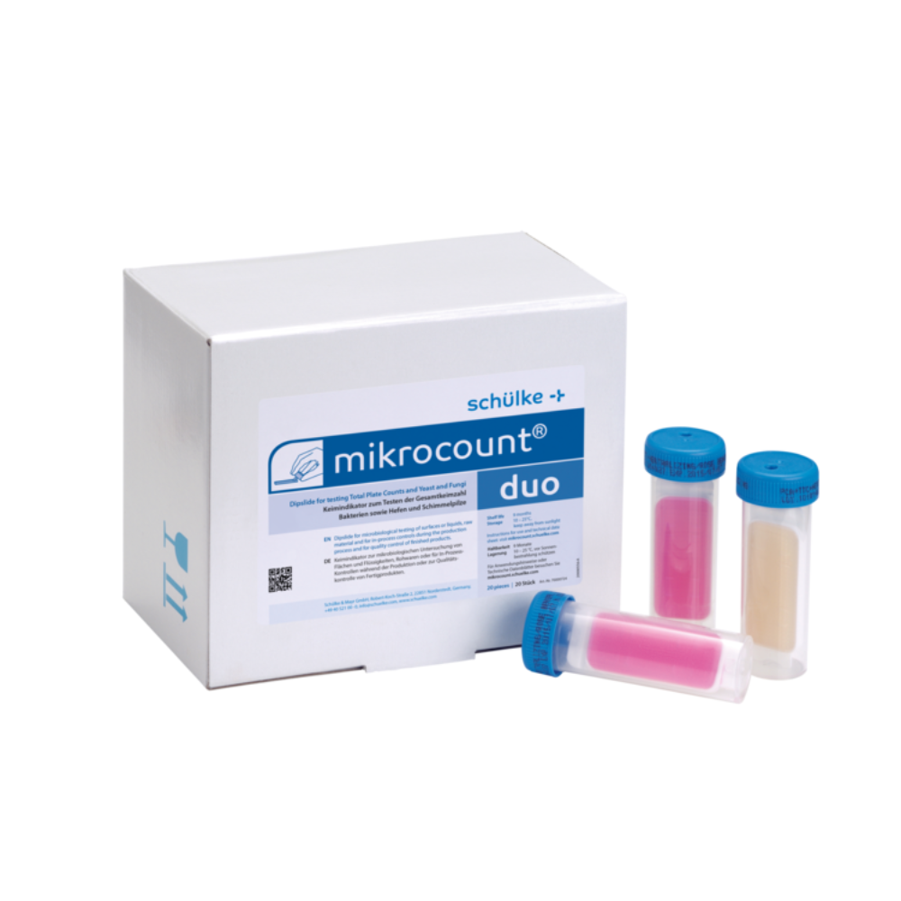 L'image montre une boîte avec l'inscription « Schülke mikrocount® duo, indicateur de germes | Paquet (20 pièces) » de la marque « Schülke & Mayr GmbH » à côté de trois tubes codés par couleur avec des bouchons bleus. Les tubes contiennent des substances roses et beiges qui sont utilisées pour détecter des micro-organismes sur des surfaces et dans des liquides, y compris les levures et les moisissures.