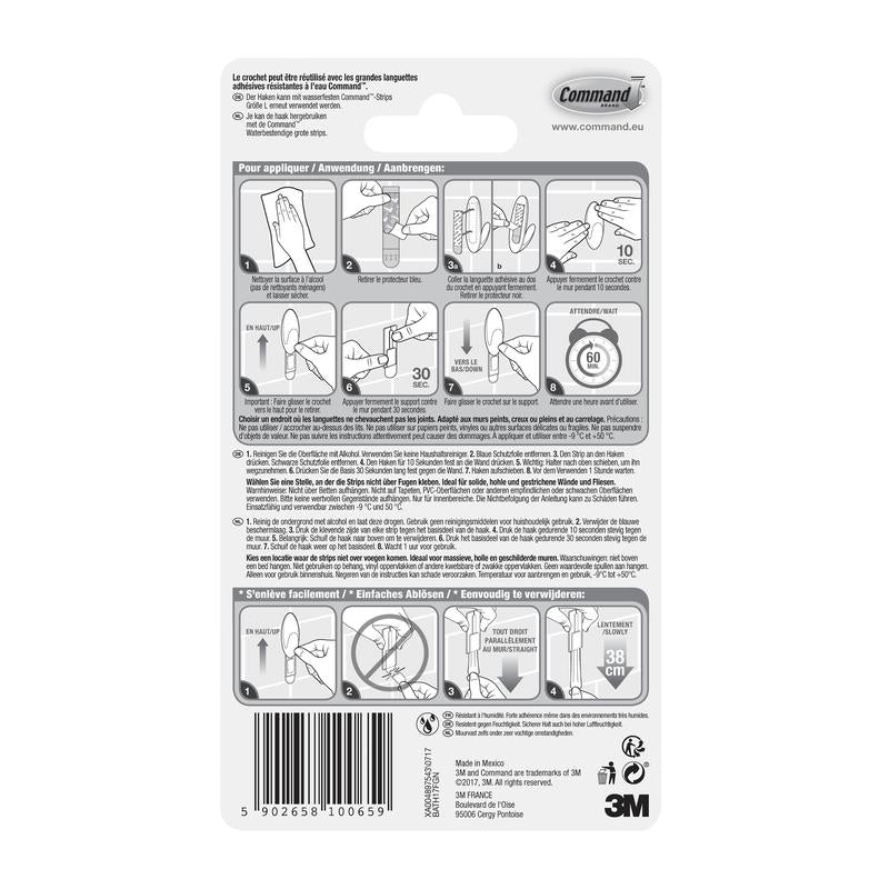 Arrière d'un emballage de crochet pour serviettes de bain Command™ de 3M Deutschland GmbH, avec des instructions illustrées pour l'application et le retrait, des consignes de sécurité et des informations sur le produit en plusieurs langues. Logo 3M et code-barres illustrés en bas.