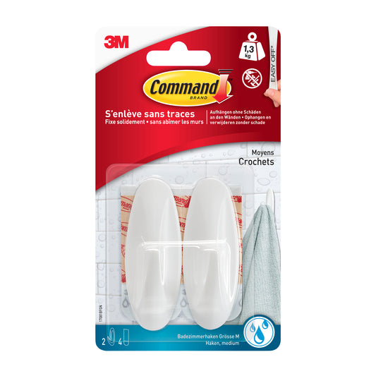 Der Command™ Bad Medium Designer-Haken, 17081B von 3M Deutschland GmbH ist eine Packung mit einem weißen Haken mit Klebestreifen in einer durchsichtigen Verpackung, der bis zu 1,3 kg hält und ohne Beschädigung wieder entfernt werden kann.