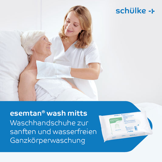 Eine Pflegekraft hilft einer älteren Frau im Krankenhausbett. Sie verwenden Schülke esemtan® Waschhandschuhe, 10er Pack | Packung (10 Handschuhe) für die sanfte, wasserlose Ganzkörperreinigung. Im Vordergrund ist die Verpackung der Waschhandschuhe zu sehen. Der Text ist auf Deutsch.